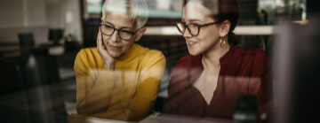 Two librarians working on a computer